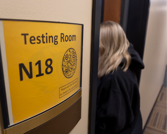 Student walking in exam room.