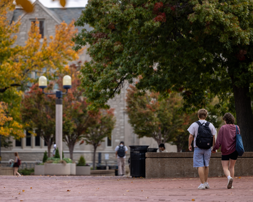 Students walking on campus during fall.
